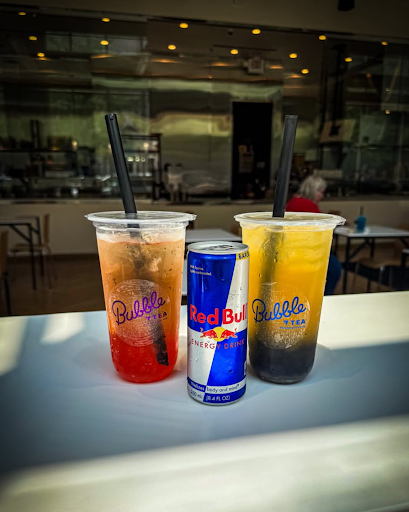 Two Balance Grille bubble teas with a Red Bull can on a table, highlighting customizable low-sugar drink options.
